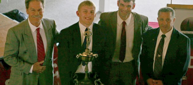 Kyle Dake (second from left) received the Hodge Trophy from WIN publisher Bryan Van Kley (second from right) and ASICS Neil Duncan (left) and Nick Gallo.